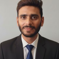 Muhammad Usman in a dark suit, professional Relnov studio portrait
